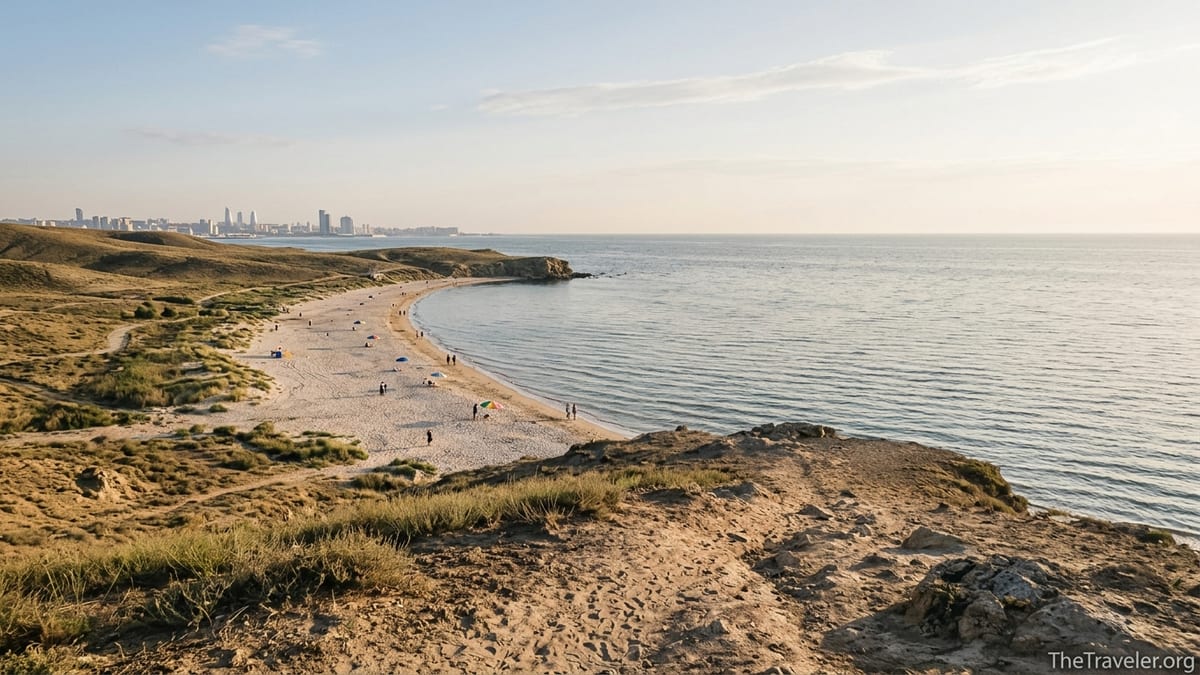 Late afternoon view of Absheron Peninsula beach curving along the Caspian Sea with distant Baku skyline.