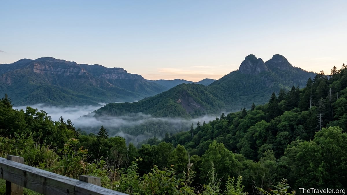 Ridgeline view of Chimney Tops and Mount Le Conte above misty forest in Great Smoky Mountains.