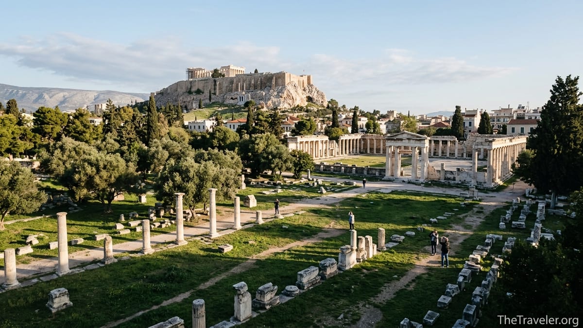 View over Athens showing the green Ancient Agora, smaller Roman Agora, and Acropolis hill in soft morning light.