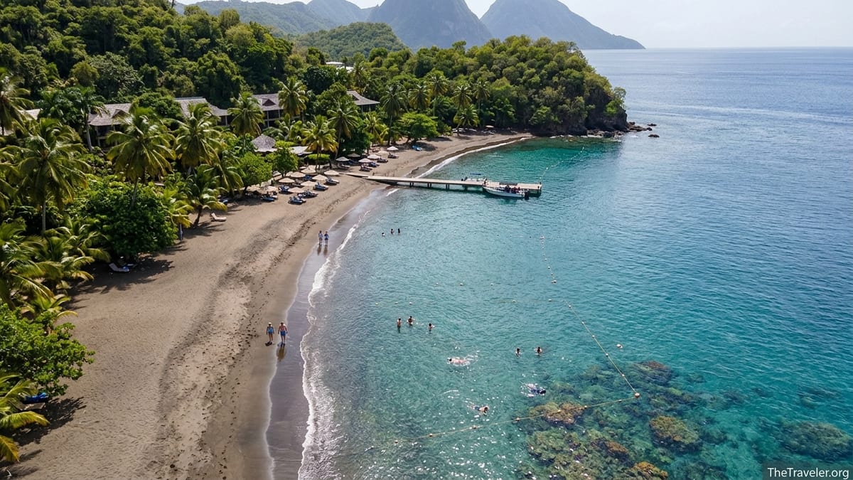 Aerial view of Anse Chastanet’s volcanic sand beach and calm turquoise bay in Saint Lucia.