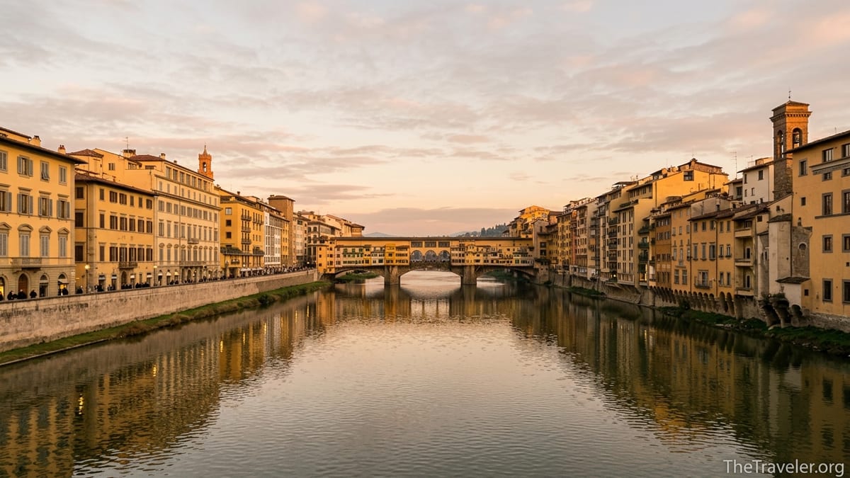Golden hour view of Ponte Vecchio and the Arno River in Florence from Ponte Santa Trinita.