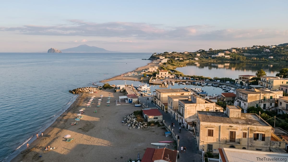 Golden hour view over Bacoli’s sandy beaches, harbor and lake near Naples, Italy.