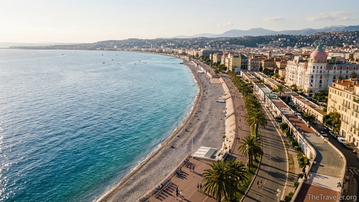 Aerial view of Baie des Anges with Nice’s Promenade des Anglais curving along a bright blue Mediterranean shoreline.