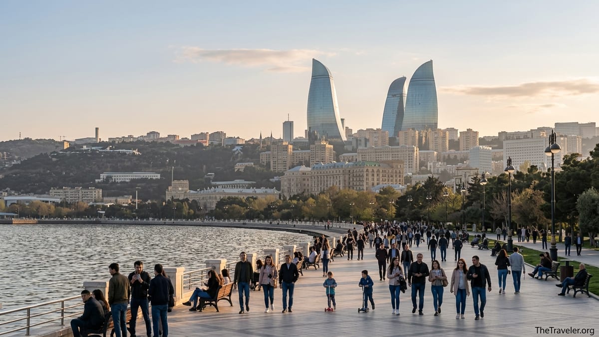 Evening view of Baku’s waterfront promenade with people walking and the Flame Towers on the skyline.