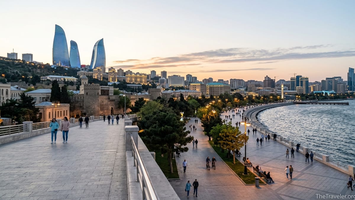 Evening view of Baku boulevard with people walking and Flame Towers lit above the Caspian Sea