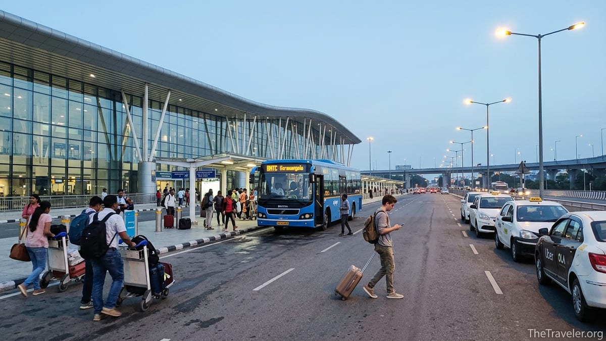 Early morning outside Bengaluru airport with Vayu Vajra bus and taxis heading to Koramangala.