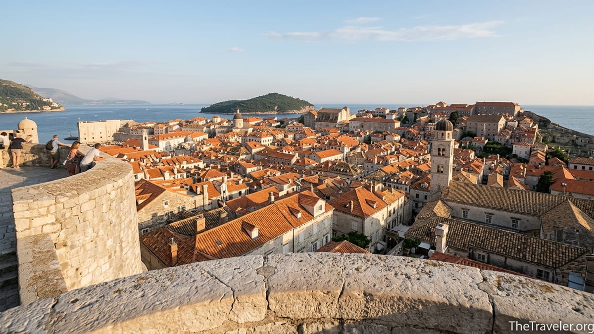 Panoramic view from Minčeta Tower over Dubrovnik’s terracotta rooftops toward the Adriatic Sea in warm late afternoon light.