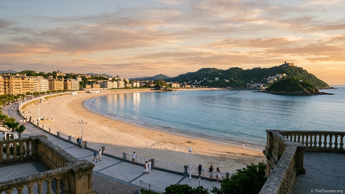 Golden hour view over La Concha Bay in San Sebastián with beach, city and green hills.