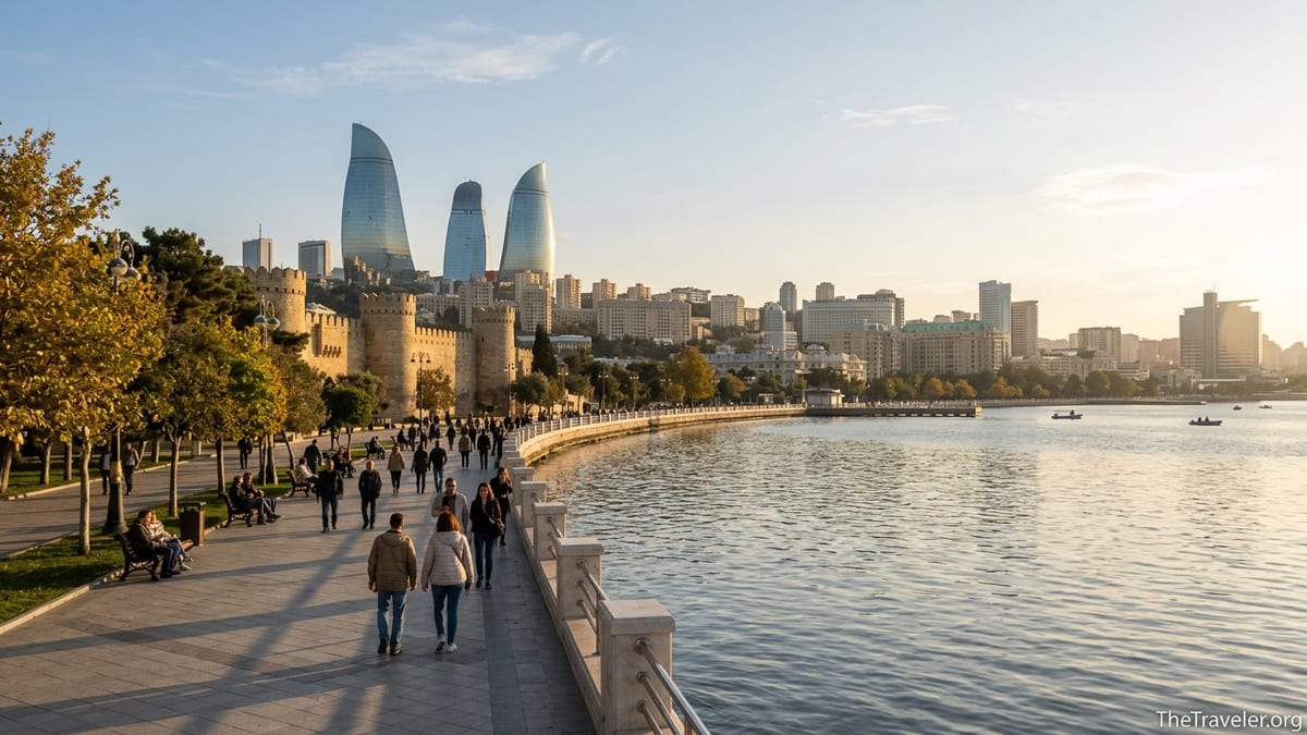 Early autumn afternoon on Baku Boulevard with people walking and Flame Towers skyline in warm light.