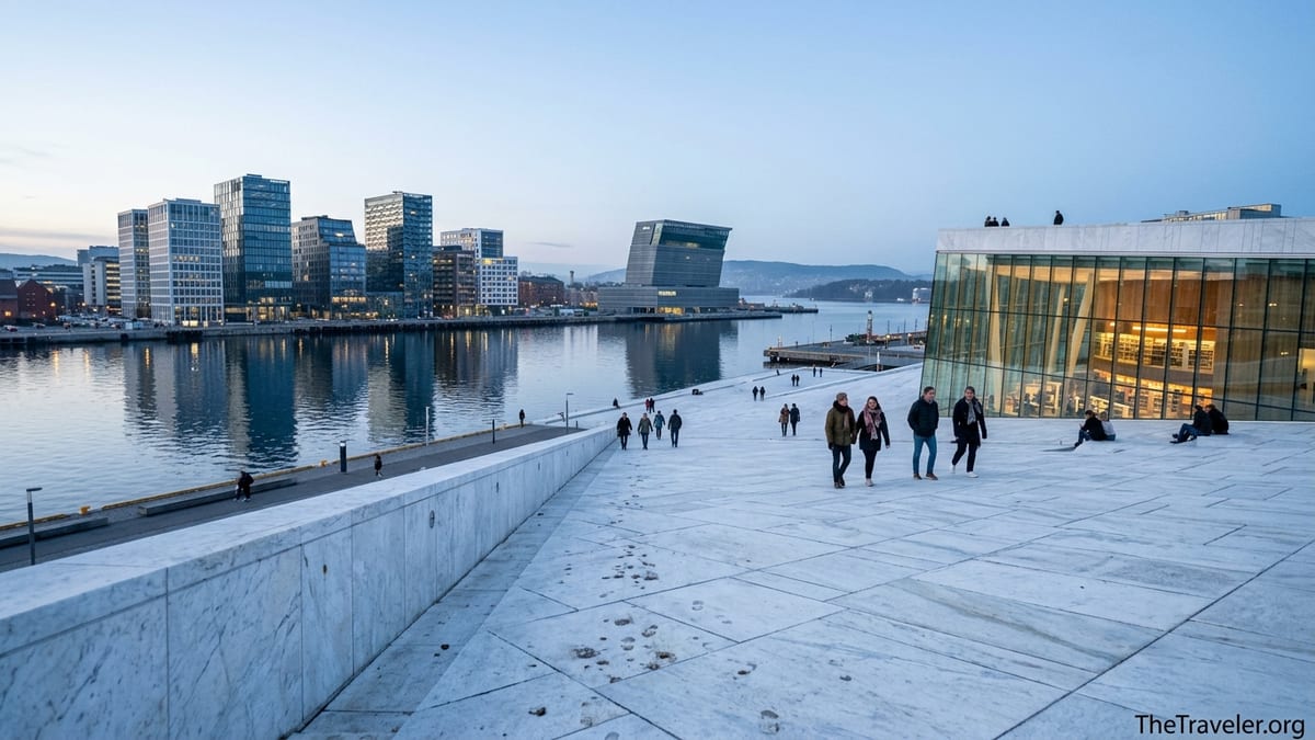 Evening view of Oslo’s Bjørvika waterfront with Opera House roof, Barcode towers and Munch museum by the fjord.
