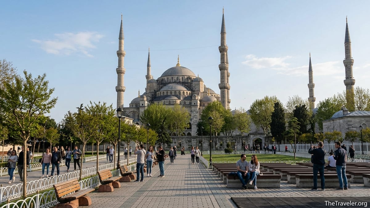 Blue Mosque rising over Sultanahmet Square with visitors walking along a tree-lined path.