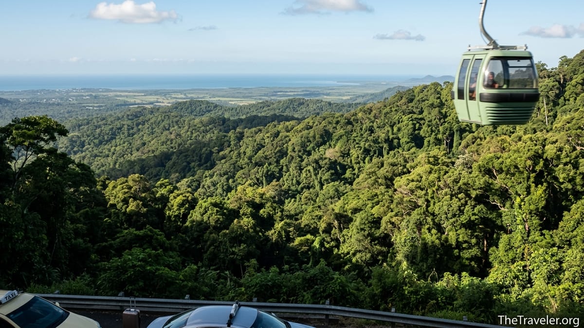 Skyrail gondola gliding above rainforest hills near Cairns on a clear day