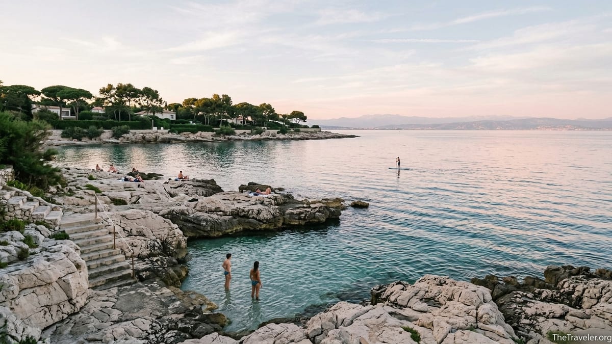 Quiet rocky cove on Cap d’Antibes at sunset with calm sea and swimmers.