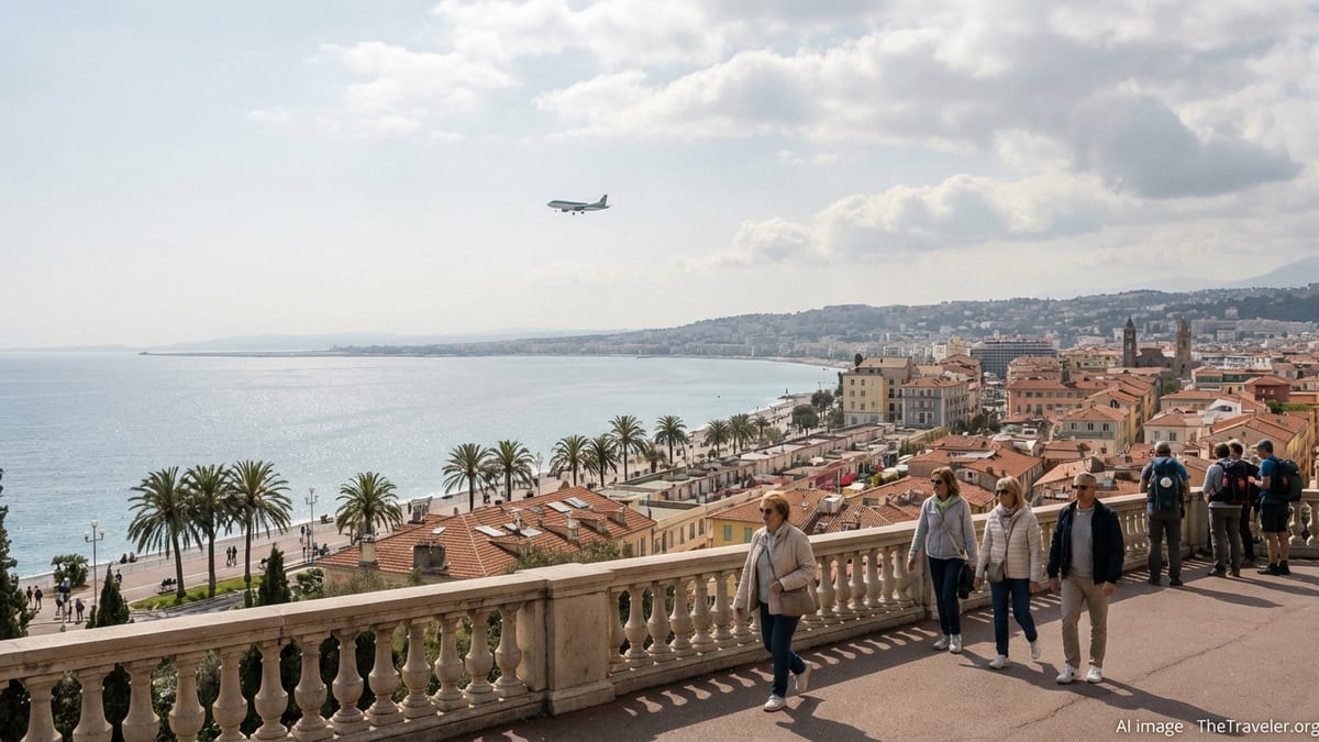 View over Nice seafront with travellers strolling the promenade and an Aer Lingus jet in the distant sky.