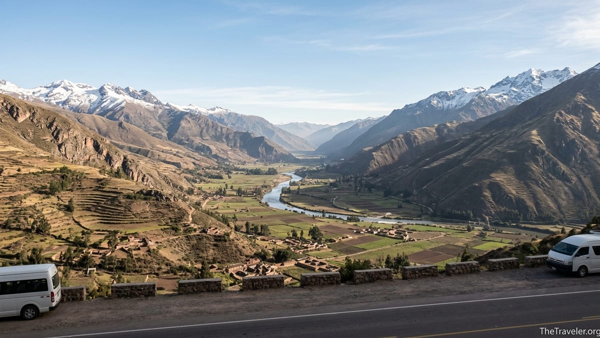 Mountain road viewpoint above Peru’s Sacred Valley looking toward Urubamba and Ollantaytambo at sunrise.