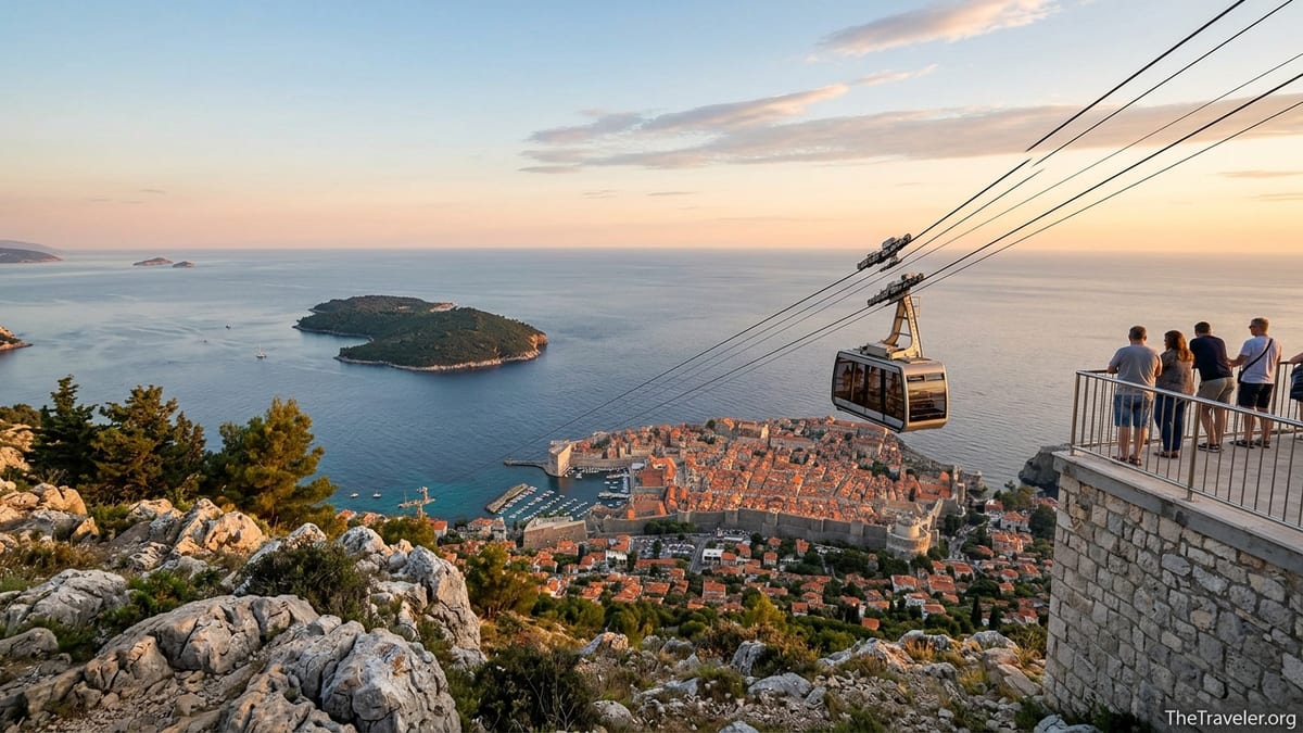 Dubrovnik cable car cabin approaching Mount Srđ with Old Town and Adriatic Sea at sunset below.