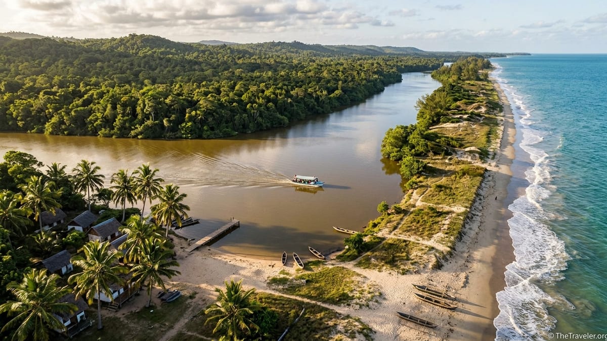Aerial view of Madagascar’s Pangalanes Canal between rainforest, lakeside huts and the Indian Ocean coast.
