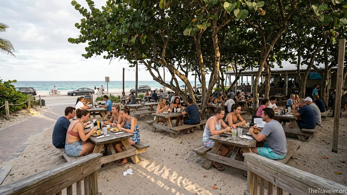 Outdoor diners at Park & Ocean restaurant under sea grape trees near the beach at Hugh Taylor Birch State Park.