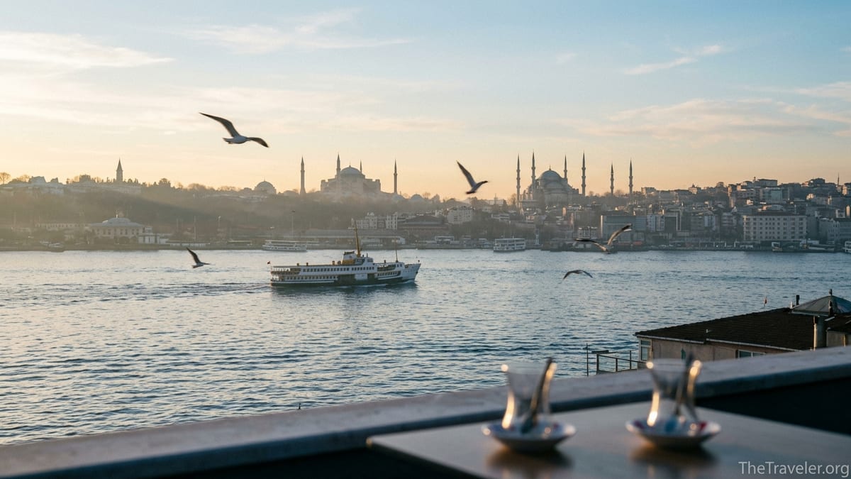 Sunrise over Istanbul’s historic peninsula with Hagia Sophia, Blue Mosque and a ferry on the Bosphorus.