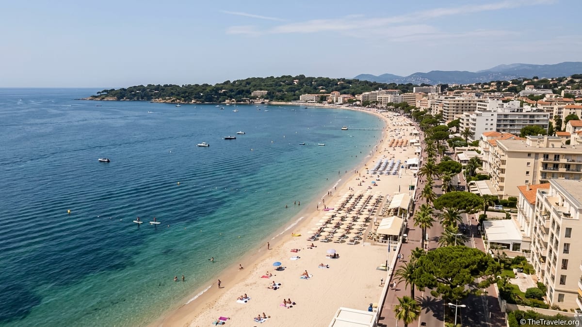 Aerial view of sandy beaches and promenade in Juan-les-Pins on a sunny summer day.