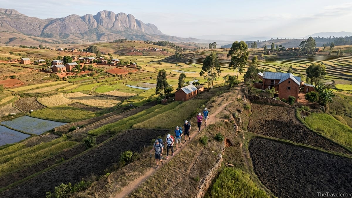 Hikers on a hillside trail above terraced rice fields near Antsirabe in Madagascar’s central highlands.