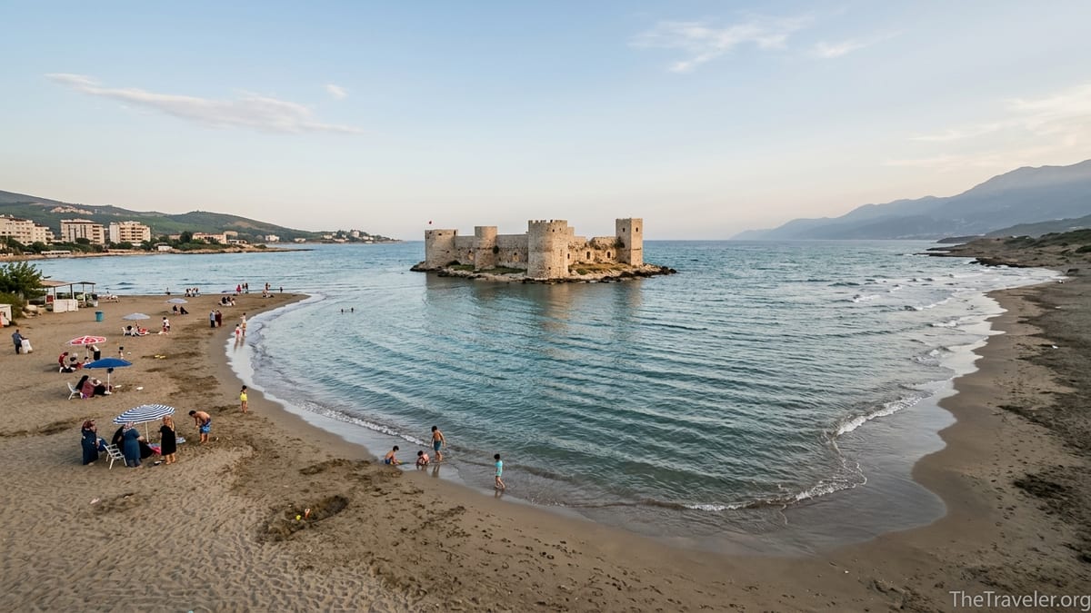 Sandy beach at Kızkalesi in Mersin with Maiden’s Castle offshore on a calm Mediterranean afternoon.
