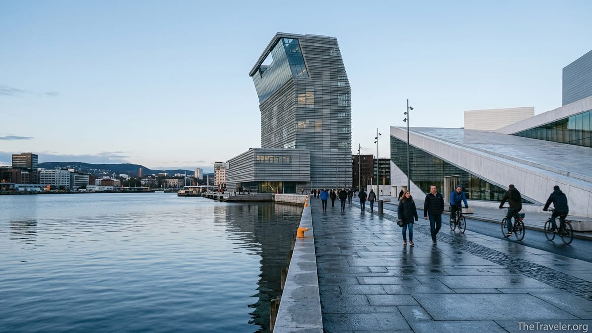 Oslo’s waterfront with the tall MUNCH museum tower and visitors walking along the harbor promenade at dusk.