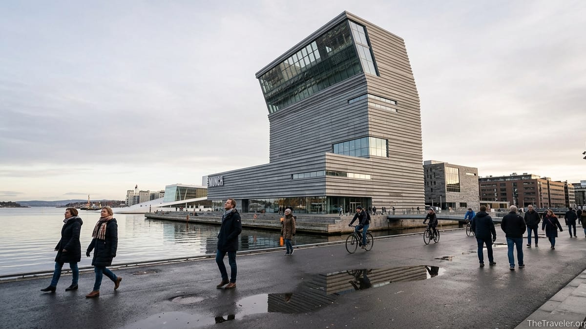 Visitors walking along the Oslo waterfront in front of the tall tilting Munch Museum building.