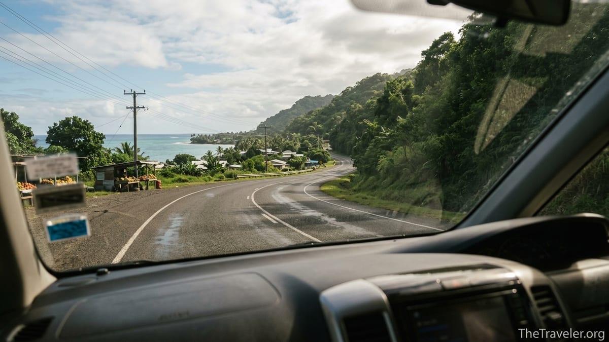 Road from Nadi to Pacific Harbour with jungle hills and coastline seen from a transfer van window.