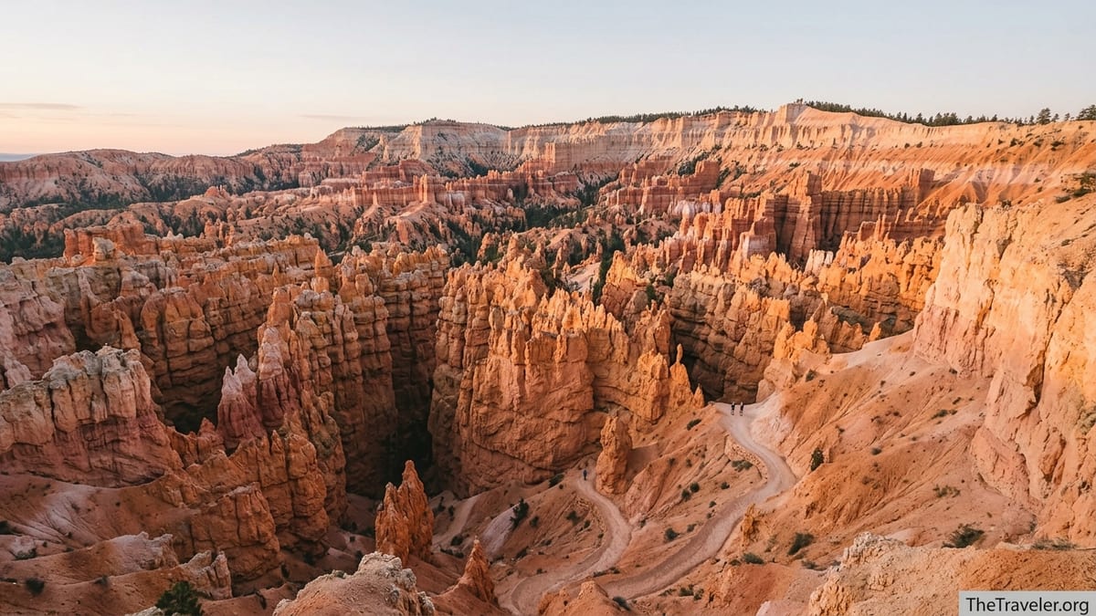 Sunrise view over Bryce Canyon hoodoos with hikers on trails below the rim.