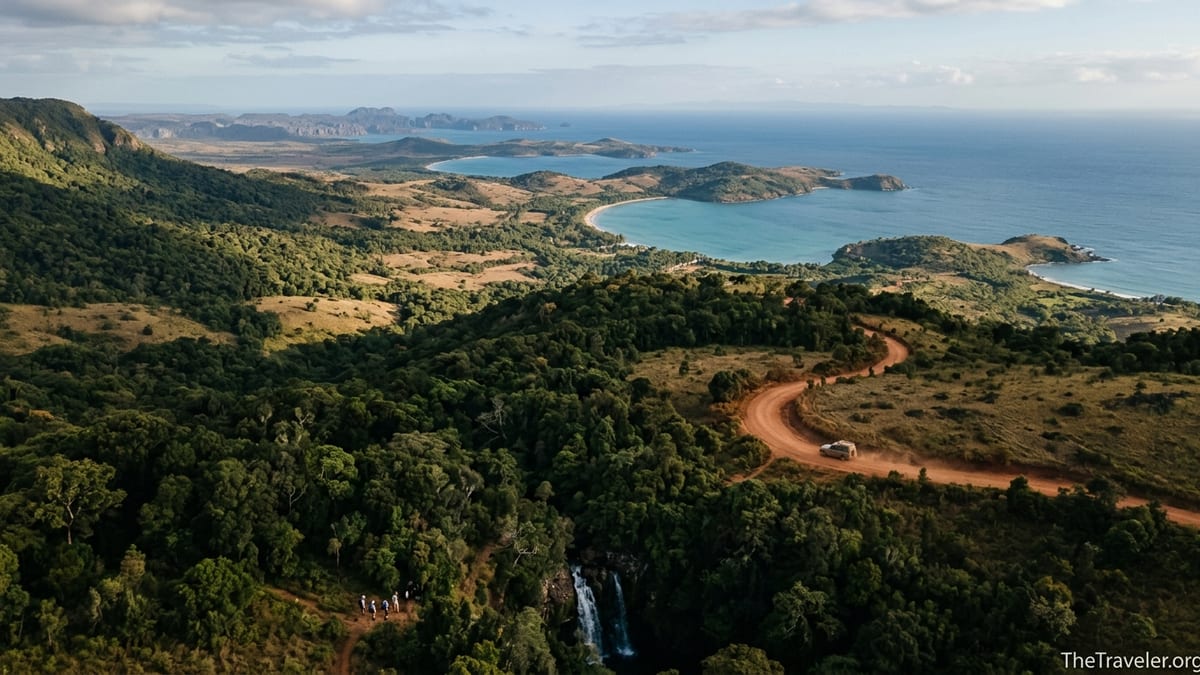 A 4x4 on a red dirt road between Amber Mountain rainforest and the blue bays near Diego Suarez in northern Madagascar.