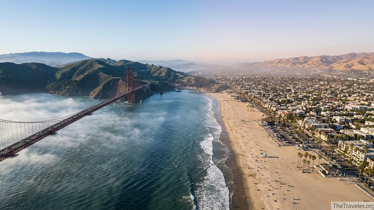 Aerial view contrasting foggy San Francisco Bay with a sunny Southern California beach city.