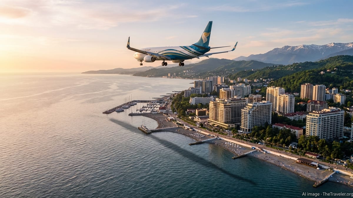 Oman Air Boeing 737 approaching Sochi over the Black Sea with city and mountains in view.