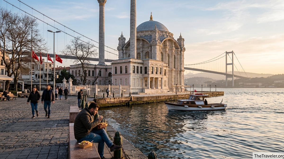 Ortaköy Mosque on the Bosphorus at sunset with the Bosphorus Bridge behind and people on the waterfront square.