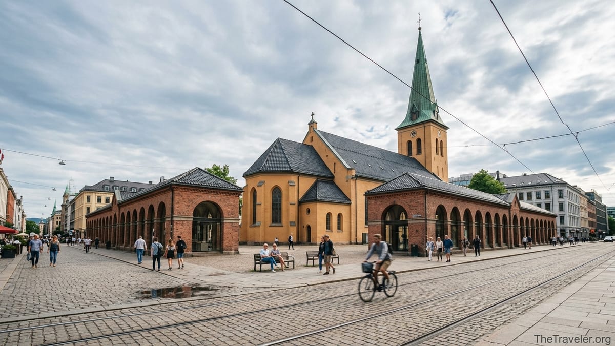 Oslo Cathedral with its tall spire and surrounding brick bazaars on a busy summer day.