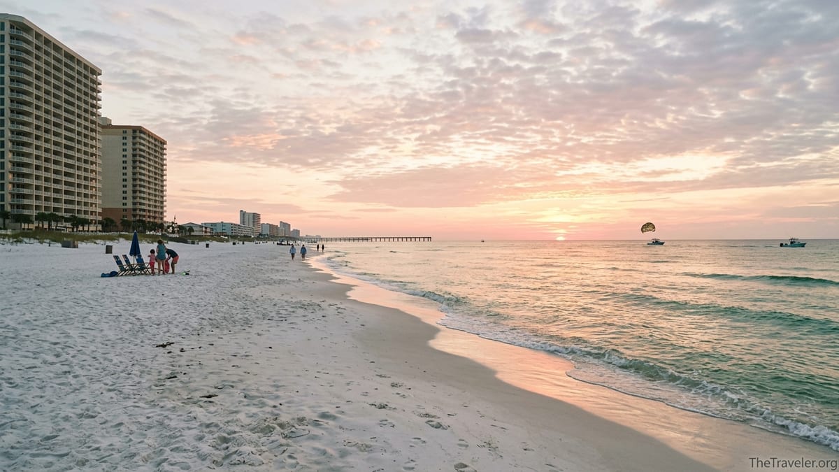 Sunrise over Panama City Beach with resort towers, piers, and gentle waves on white sand.