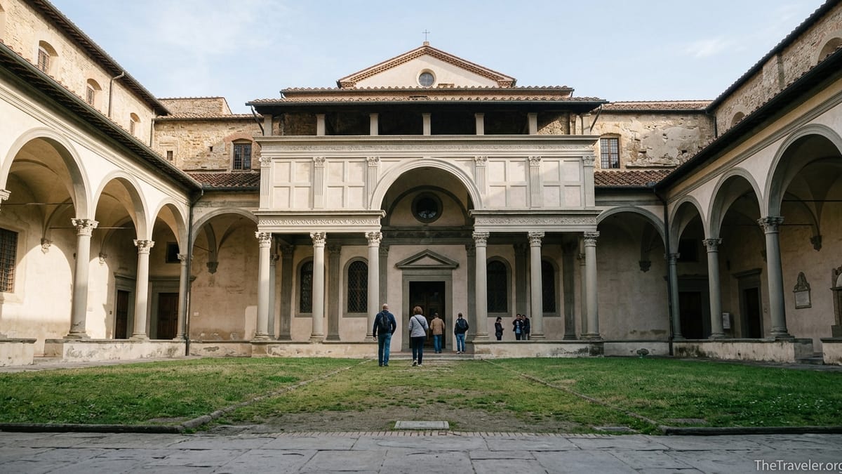 Pazzi Chapel facade seen from the cloister of Santa Croce in Florence on a sunny morning.