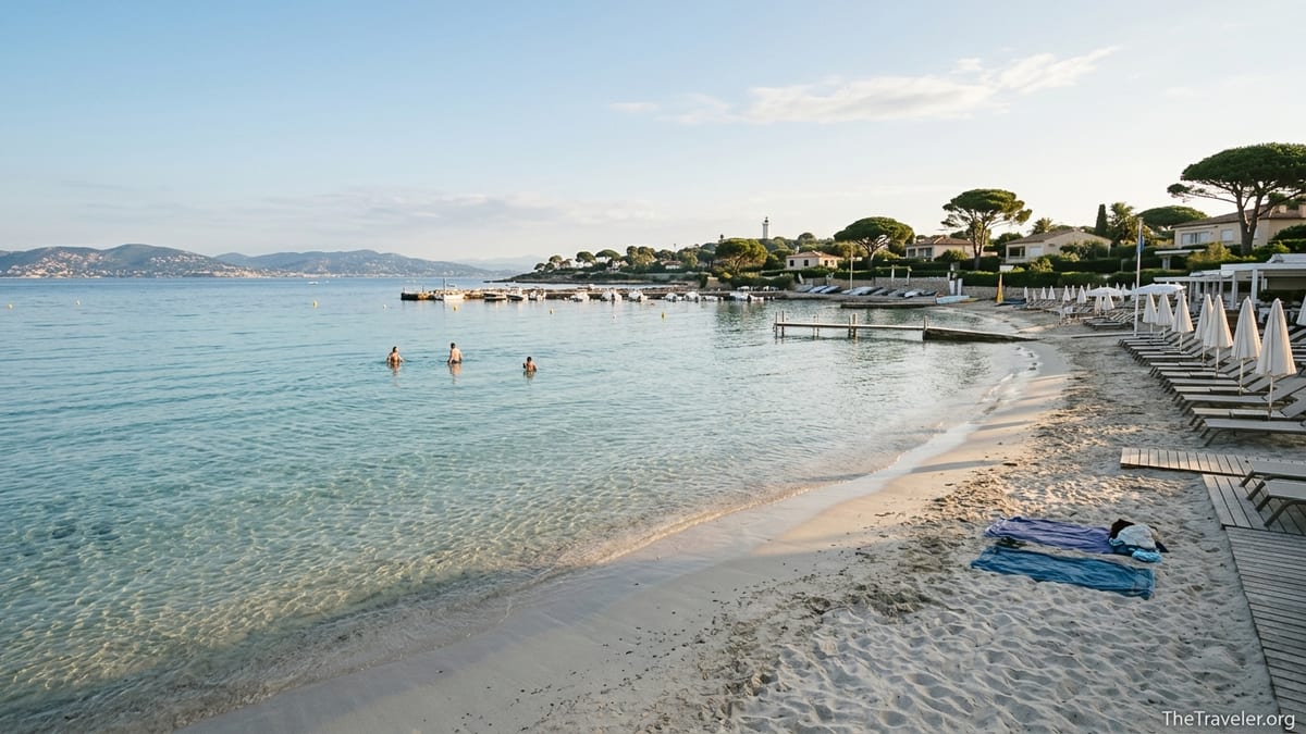 Soft sandy Plage de la Garoupe with clear turquoise water and quiet early-morning swimmers on Cap d’Antibes.