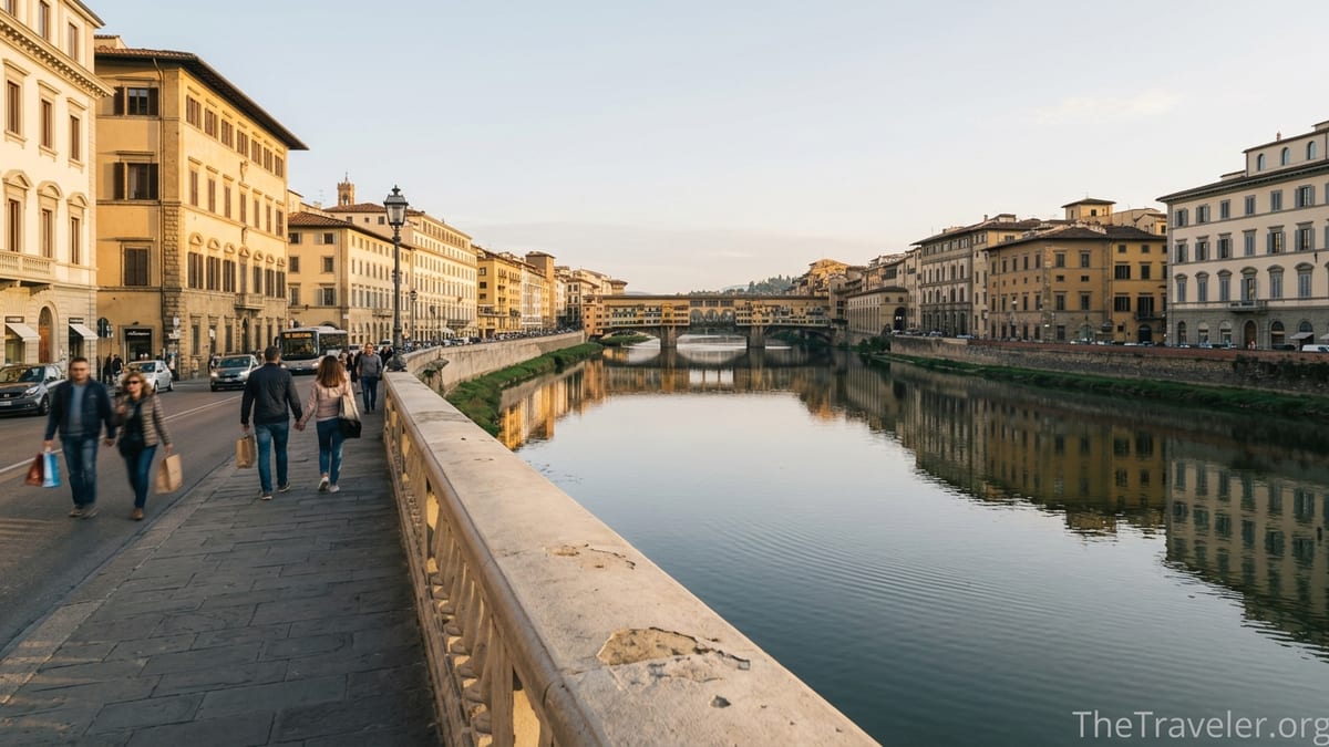 Golden hour view of the Arno River from Ponte alla Carraia in Florence with reflections and distant Ponte Vecchio.