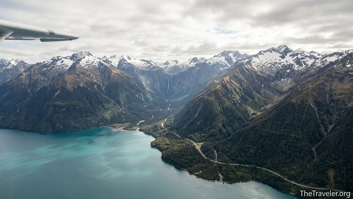 Aerial view from a small plane flying from Queenstown towards Milford Sound over mountains and Lake Wakatipu.