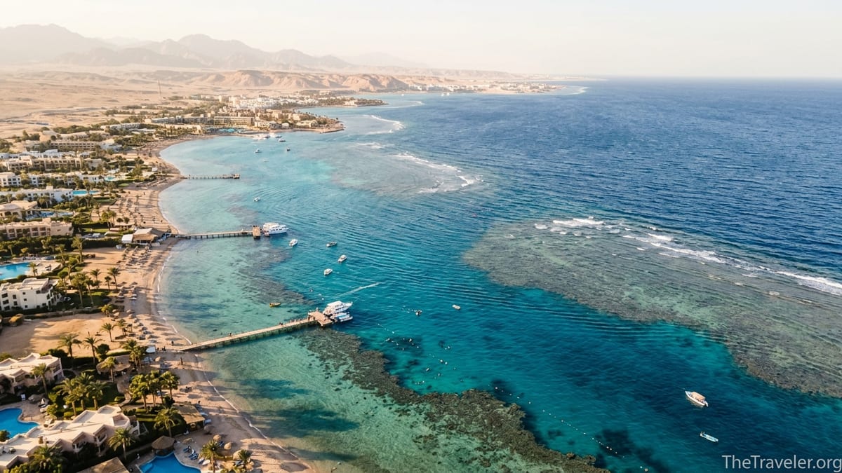 Aerial view of Egypt’s Red Sea coast with reefs, beaches and low-rise resorts at sunset.