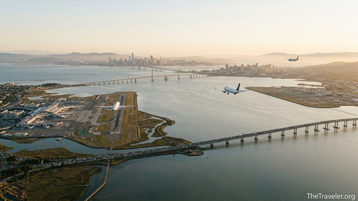 Aerial view of all three San Francisco Bay Area airports with planes approaching over the bay.