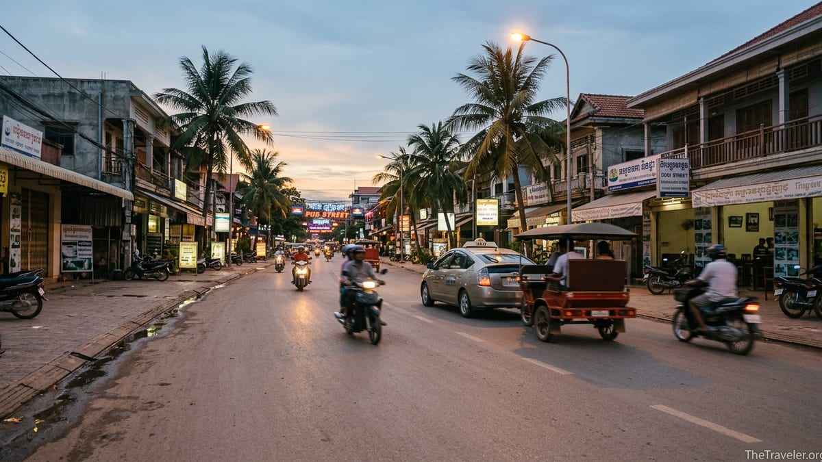Taxi and tuk-tuk driving toward central Siem Reap at dusk near Pub Street.