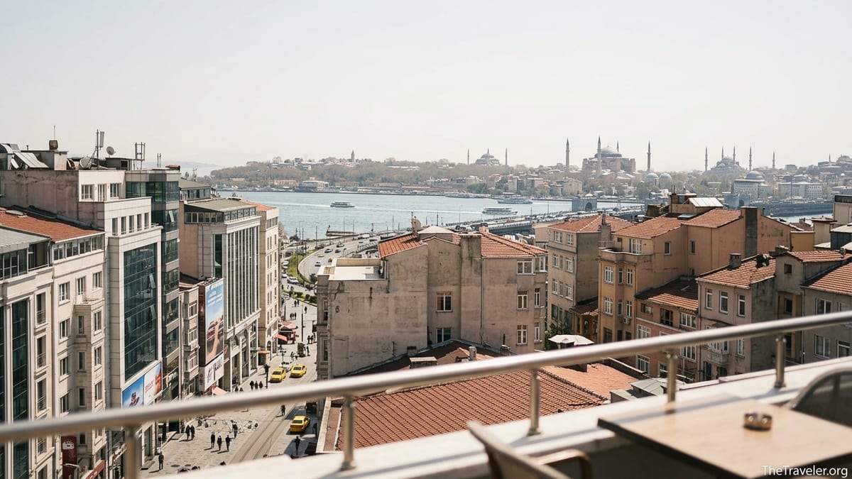Panoramic rooftop view over Taksim and Sultanahmet skylines with Bosphorus in the distance.