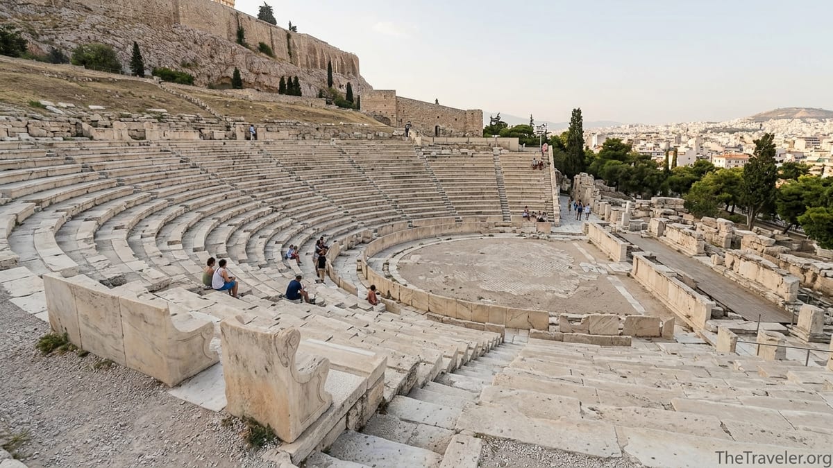 Curved stone seating of the Theatre of Dionysus below the Acropolis in Athens under soft afternoon light.