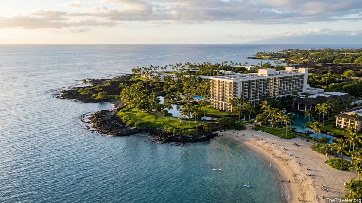 Aerial view of Hilton Ocean Tower Waikoloa and nearby bay along the Kohala Coast at sunset.