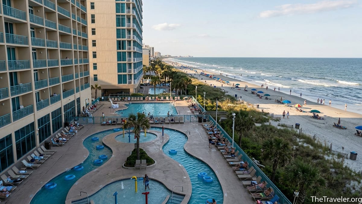 Oceanfront family pool and lazy river at Westgate Myrtle Beach with resort tower and sandy beach in late afternoon light.