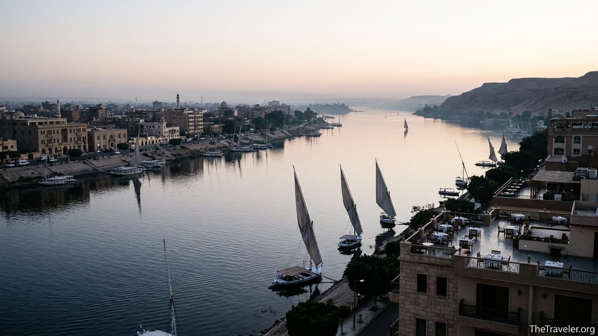Early morning view over the Nile in Luxor with feluccas and riverside hotels.