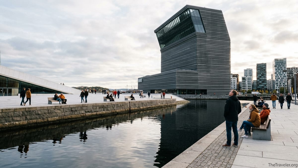 Exterior view of Oslo’s Munch Museum tower on the Bjørvika waterfront with visitors on the quay.